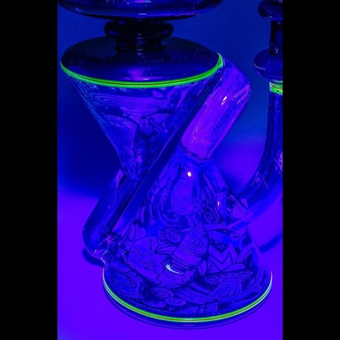 Close-up of the ultraviolet-lit glass recycler by Robert Mickelsen, showing the glowing green rings