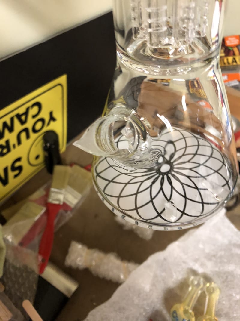 A clear water pipe etched with a fine geometric flower pattern