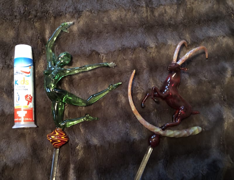 Two figurative glass dab tools worked as long-limbed creatures in green and red