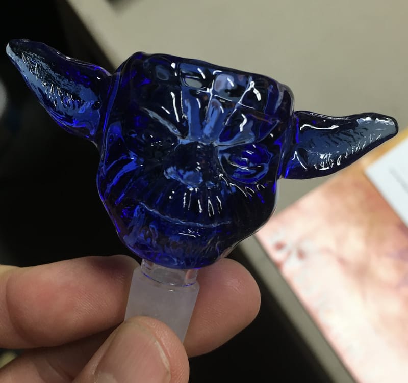 A cobalt blue glass bowl worked as a character head with long ears
