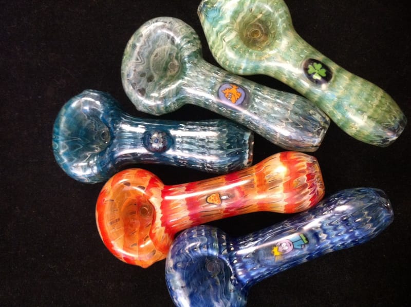Five assorted hand pipes in blue, green, orange and clear, several with coloured dot work
