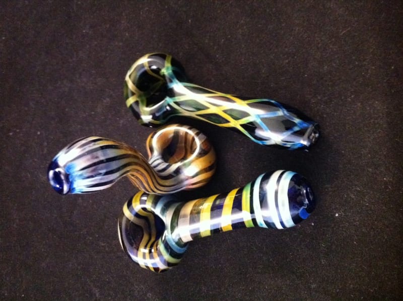 Three hand pipes worked in black, gold and blue stripes