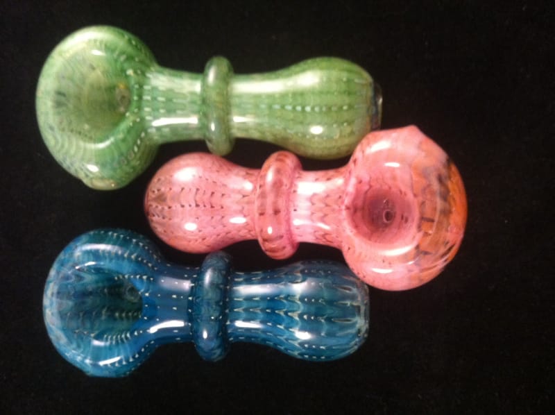 Three hand pipes in green, pink and teal with ribbed grips