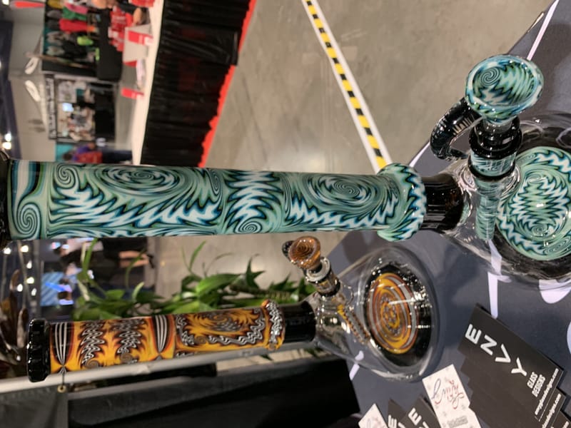 Detail of a teal water pipe wrapped in carved leaf patterning