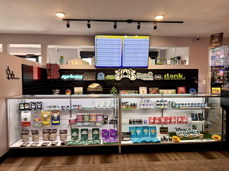 The lit product case at Dryden Dispensary, stocked with packaged flower and edibles